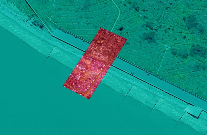 A blue/green tinted aerial image of a section of coastline, overlaid with a red tinted image of an allotment, demonstrating the proposed intertidal allotment as seen from above.